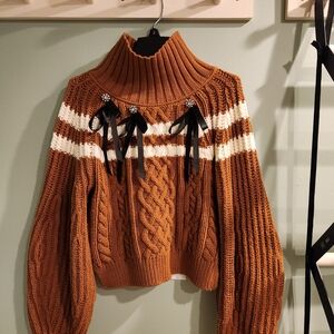 Maeve Rust Cable Knit Turtleneck Sweater with White Stripes and Black Ribbon